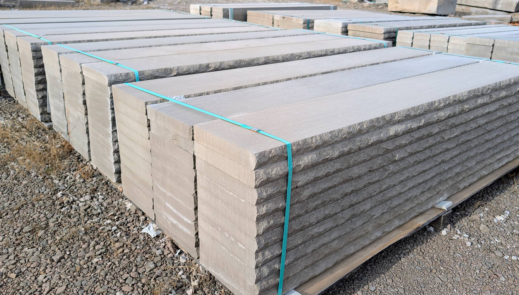 Stacked limestone treads with a textured finish, secured with straps at BG Hoadley Quarries in Bloomington, Indiana.